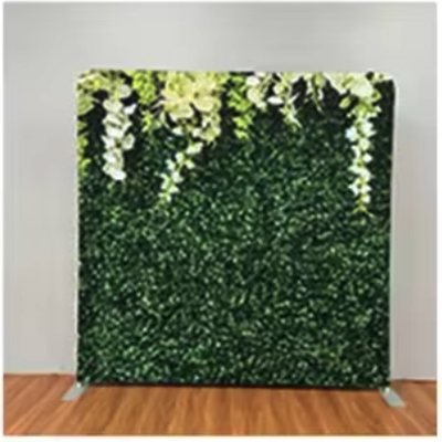 Green boxwood photo booth backdrop with cascading white flowers along the top
